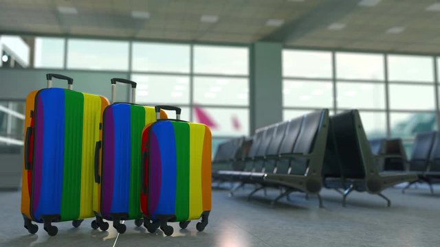 Travel suitcases with gay pride flag. LGBT tourism or immigration conceptual animation