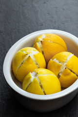 Moroccan preserved salted lemonson black stone background