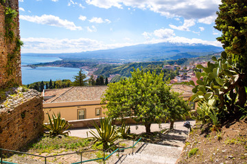 Beautiful view to Etna volcano from ancient Greek theatre. Clear blue sky, Taormina, Sicily island, Italy. 