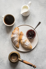 Cup of coffee and freshly baked croissants. Top view. Flat lay. Concept french breakfast.