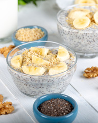 Chia pudding made with milk, banana and decorated with walnut