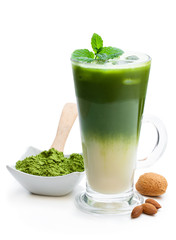 Homemade layered iced matcha latte tea with almond milk isolated on white