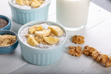 Chia pudding made with milk, banana and decorated with walnut