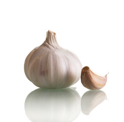 Head fresh garlic and one clove isolated on white