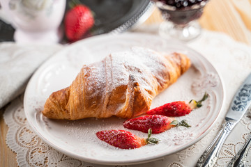 freshly baked croissants on grey wooden table, top view