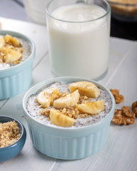 Chia pudding made with milk, banana and decorated with walnut