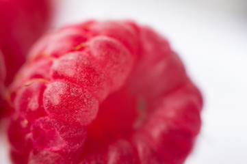 raspberries on a white saucer close up, macro photo