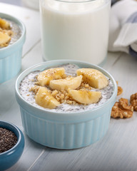 Chia pudding made with milk, banana and decorated with walnut