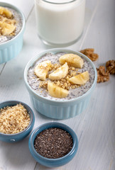 Chia pudding made with milk, banana and decorated with walnut