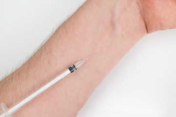 Insuline injector on the arm. Drug addiction. Dependence on insulin concept. Closeup on light background.