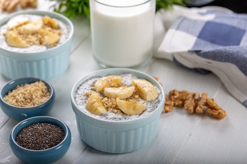 Chia pudding made with milk, banana and decorated with walnut