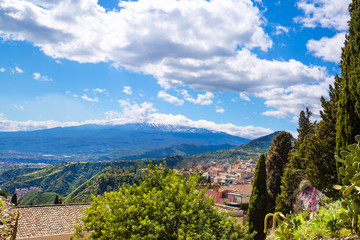 Fototapeta na wymiar Beautiful view to Etna volcano from ancient Greek theatre. Clear blue sky, Taormina, Sicily island, Italy. 