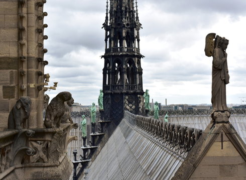 Notre Dame Spire, La Fleche, and lead clad wooden roofs before the fire. View of the Apostles, angel statue, chimeras and gargoyles. Paris, France.