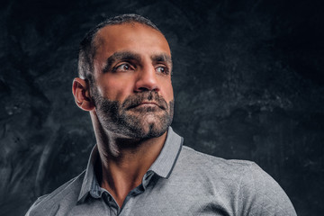 Close-up a handsome Caucasian male wearing a gray shirt.