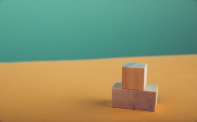 Concept of growth in business,stack of wooden block on yellow green background