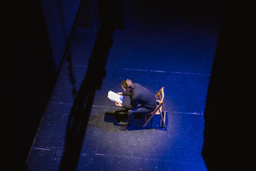 Actor reviewing script in stage.