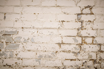 Wall is made from bricks and painted with white color.
