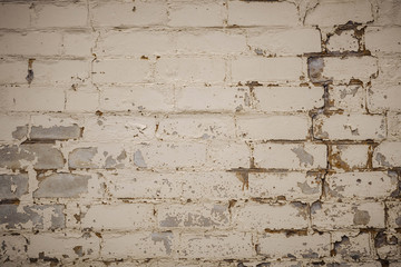 Wall is made from bricks and painted with white color.