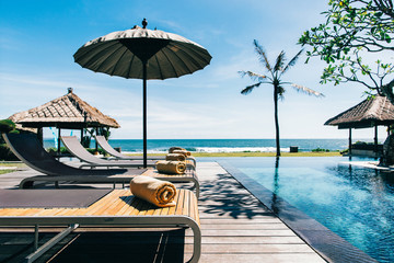 Tropical Living - Sunbeds Near High-End Oceanfront Swimming Pool