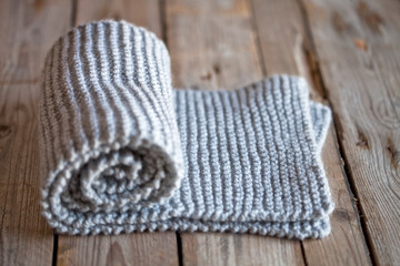 Fototapeta na wymiar Hand knitted grey scarf.