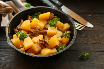 stewed potatoes with meat, goulash. stewed main course. food background. top
