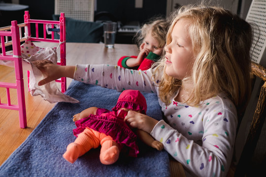 Little Girl Playing With Doll