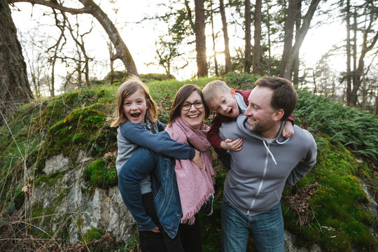 Fun family of four spending time together in nature