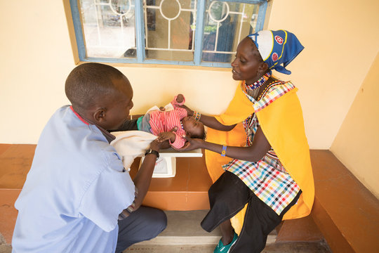Doctor examining baby.