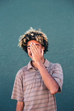 Multiracial teen with afro hair laughing