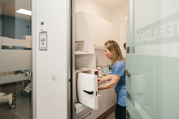Clinic staff performing the dental tools sterilization