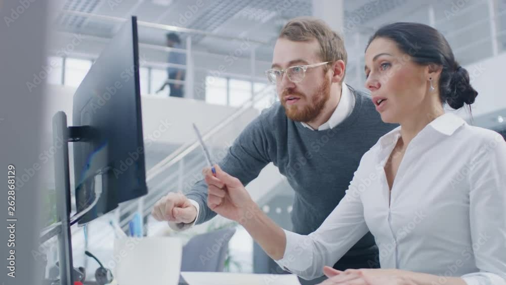 Poster beautiful businesswoman uses desktop computer, consults her project manager about documents with gra