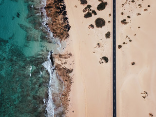 Aerial view of an empty road through the desert with copy space