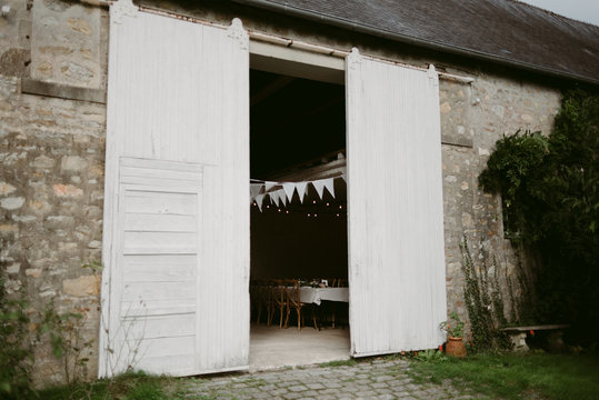 Bunting and table set up for wedding inside old stables