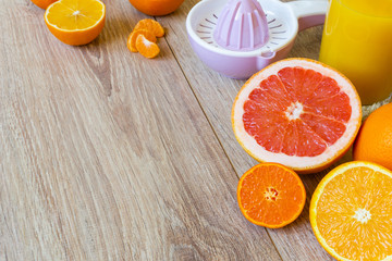 various citrus fruits, reamer and juice