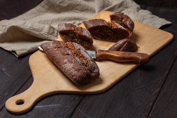Freshly baked homemade rye bread with herbs and garlic butter. Sliced on a cutting Board. 