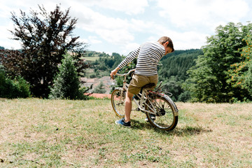 boy sitting on vintage bike