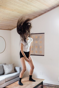 woman flipping hair back indoors during day time