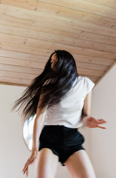 female dancing with hair moving back and forth