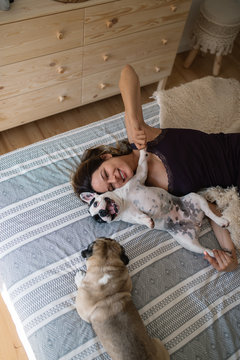 Young woman in bed with her dogs