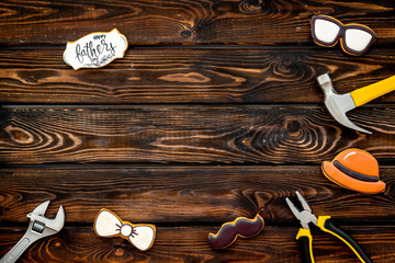 bow tie, moustache, glasses, hat and instruments for rapair for Happy Father Day on wooden background top view mokeup