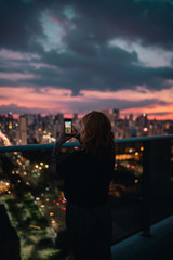 Girl using a phone in sunset