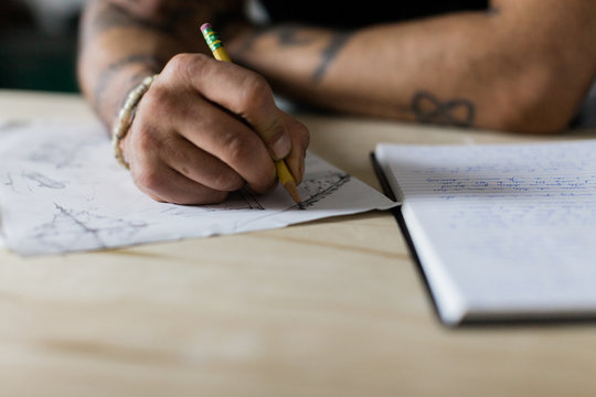 detail of artist sketching on paper