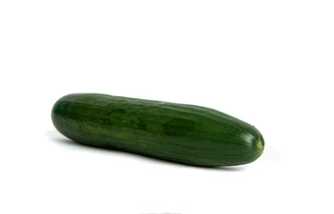 Green cucumber Isolated on white. Ground cucumber ready to be cooked. The cucumber lies on the counter, the concept of cooking and preparing a meal. Dishes for vegetarians.