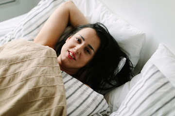 happy woman on the bed