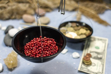 composition with scales, red pepper and coins