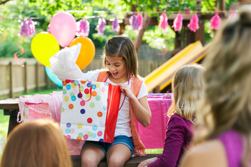 Birthday: Girl Looking Into Gift Bag For Present