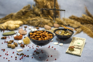 composition with scales, nuts almonds and coins