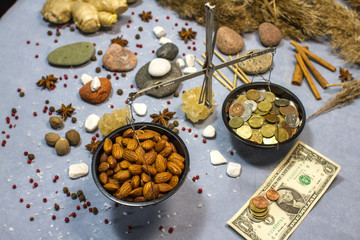 composition with scales, nuts almonds and coins