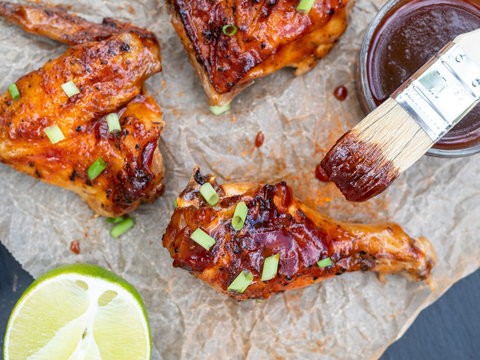 Chicken grilled on a barbecue and covered with tangy lime bbq sauce and chopped green onions.