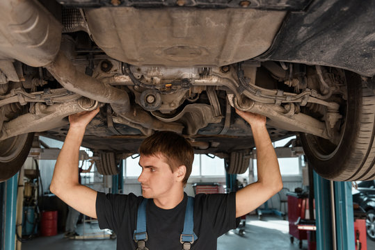 Man under car exploring suspension